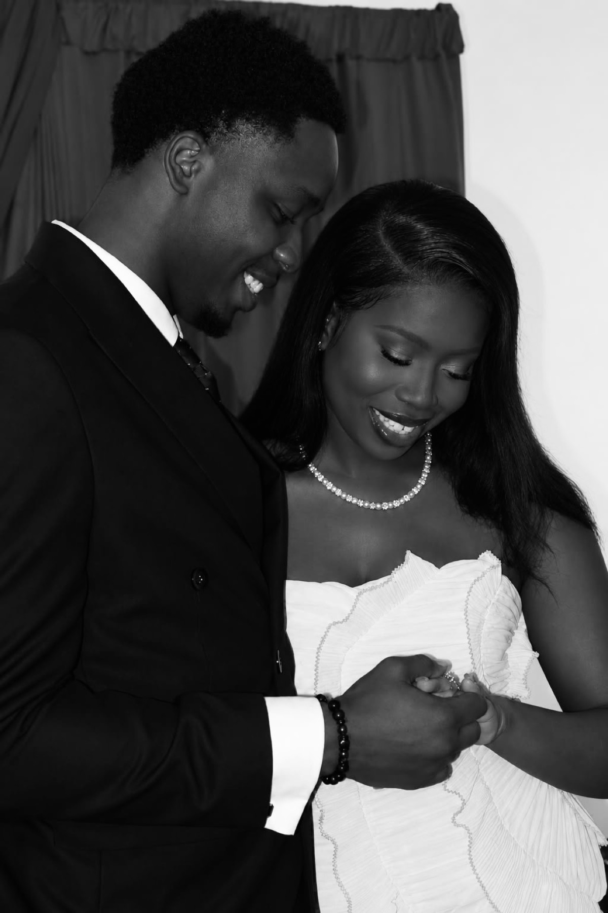 Mosope and Ibukun looking down at her ring